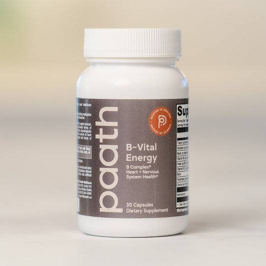 Supplement bottle labeled 'B-Vital Energy' by paath on a neutral background