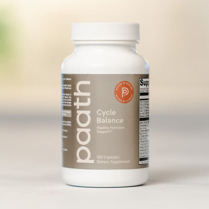 Supplement bottle labeled 'Cycle Balance' on a neutral background
