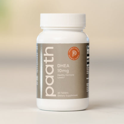 Supplement bottle labeled 'paath DHEA 10mg' on a beige background
