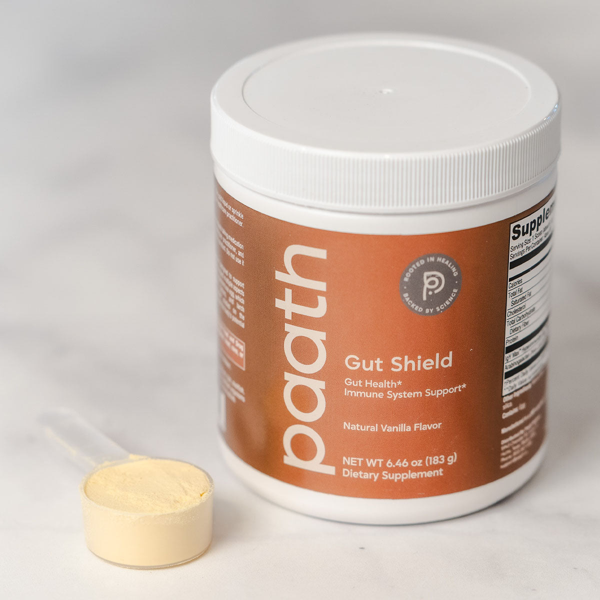 Paath Gut Shield supplement container with a scoop on a white background
