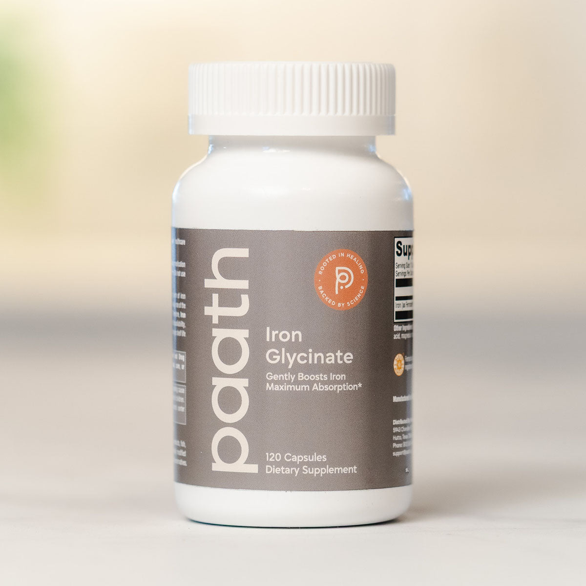 Supplement bottle labeled Iron Glycinate on a neutral background