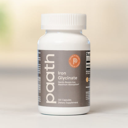 Supplement bottle labeled Iron Glycinate on a neutral background