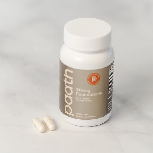 Supplement bottle labeled 'paath' with capsules on a light gray background