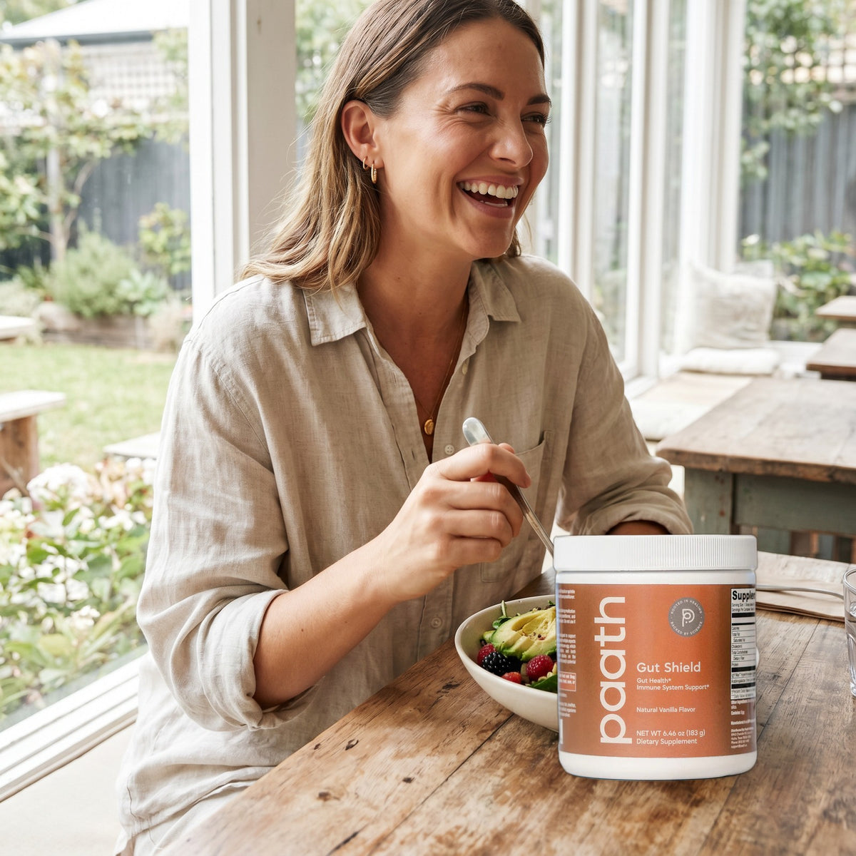 Woman enjoying a fresh salad beside Paath Gut Shield