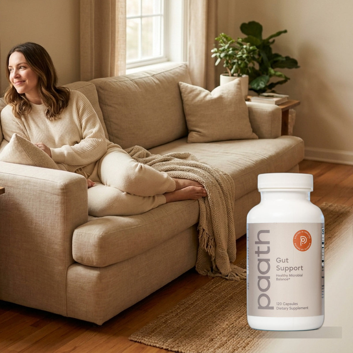 Woman relaxed and comfortable on a sofa with Paath Gut Support