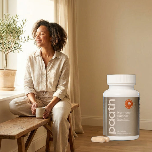 Woman calm and balanced by a bright window with Paath Hormone Balance
