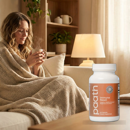 Woman wrapped in a blanket with warm tea at the first sign of a cold, with Paath Immune Reset