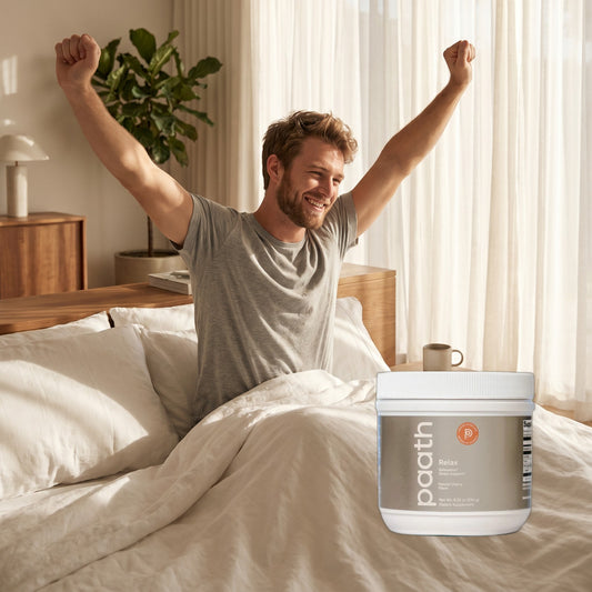 Man waking rested and stretching in bed beside Paath Relax